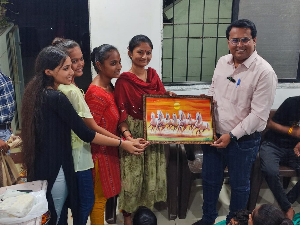 Jivanvidhya Academy female students presenting a painting to Hitesh Sir and guest