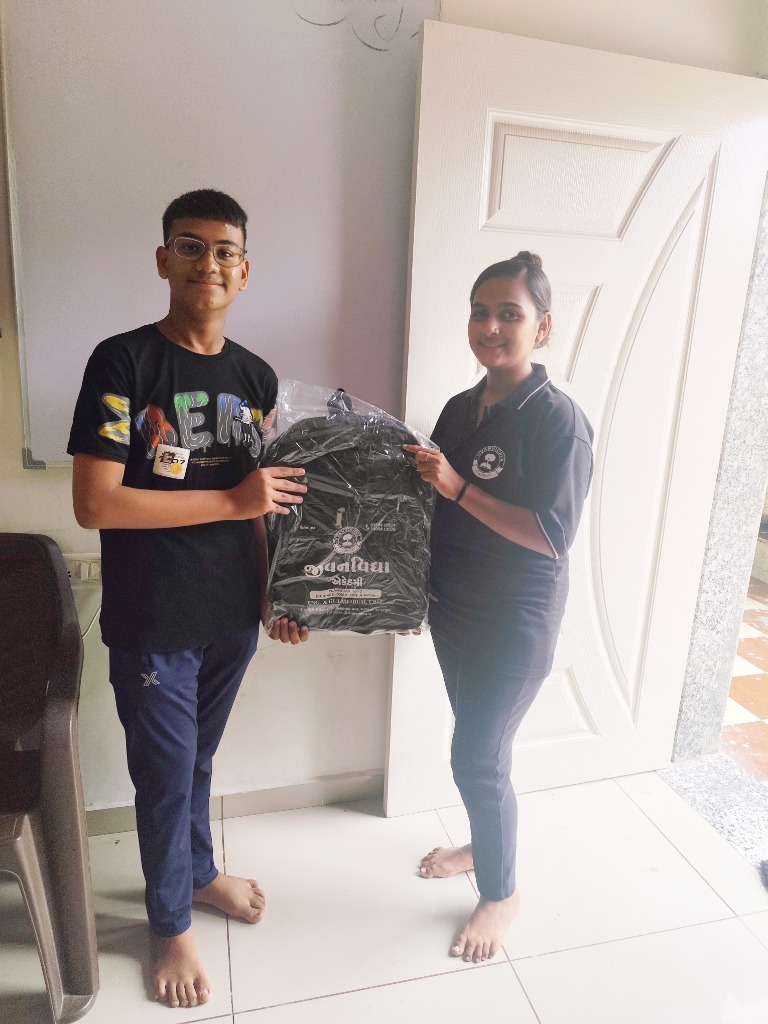 Academy student and mentor presenting Jivanvidhya school bag