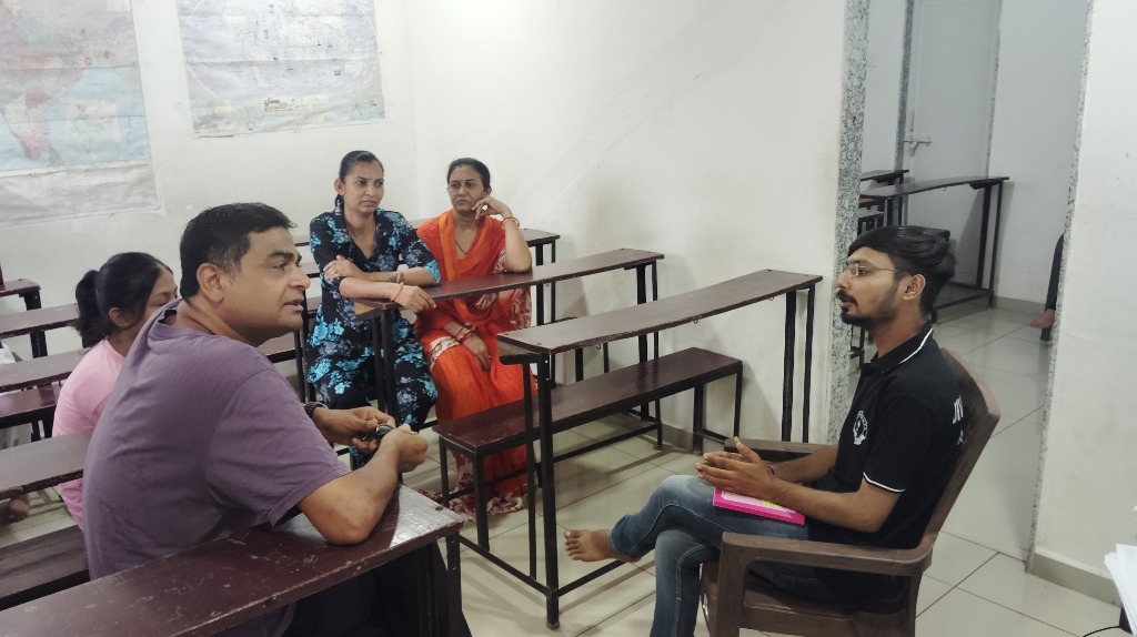 Parents and students discussing progress report in study room